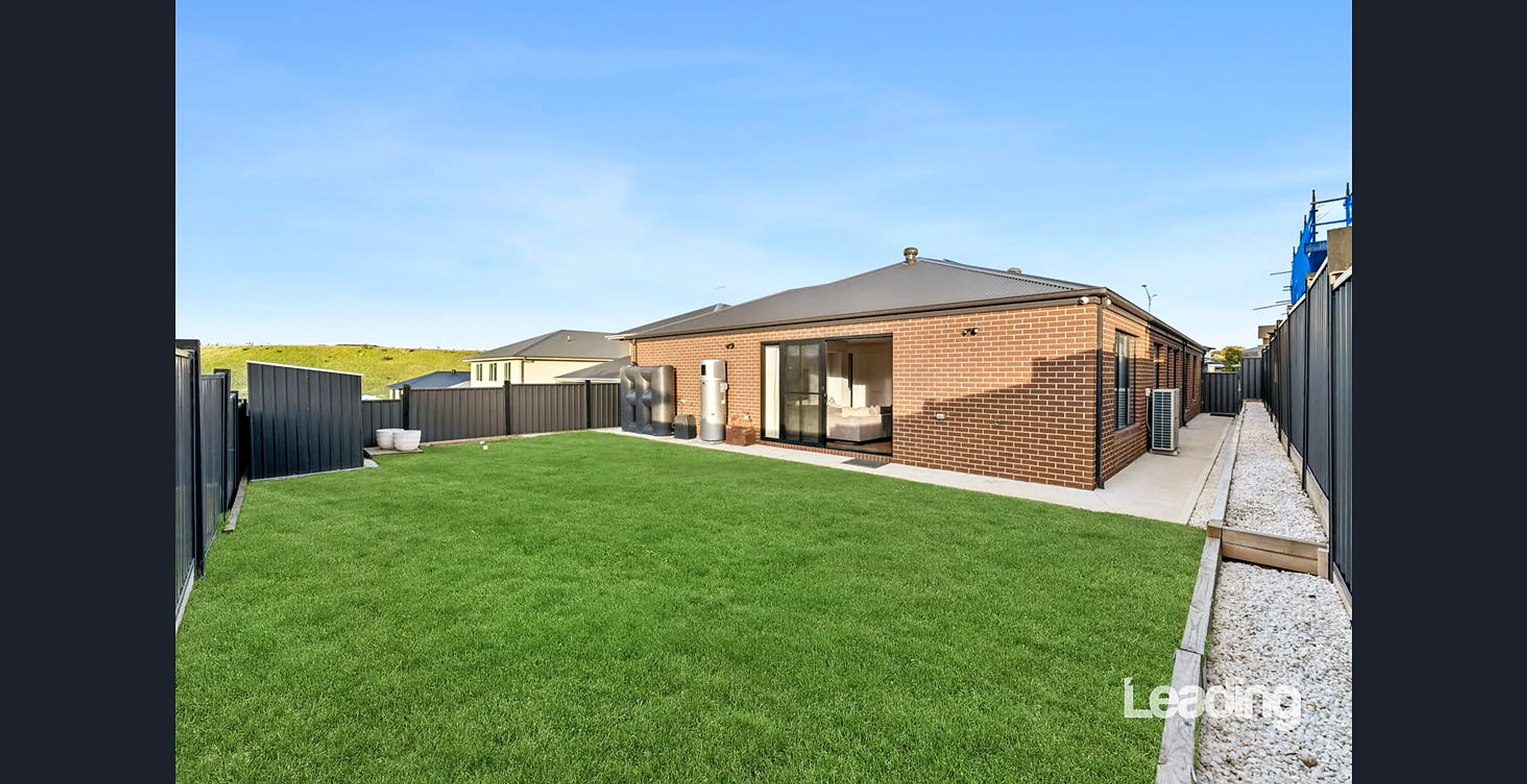 Fully fenced, landscaped rear yard with entertaining area and storage shed