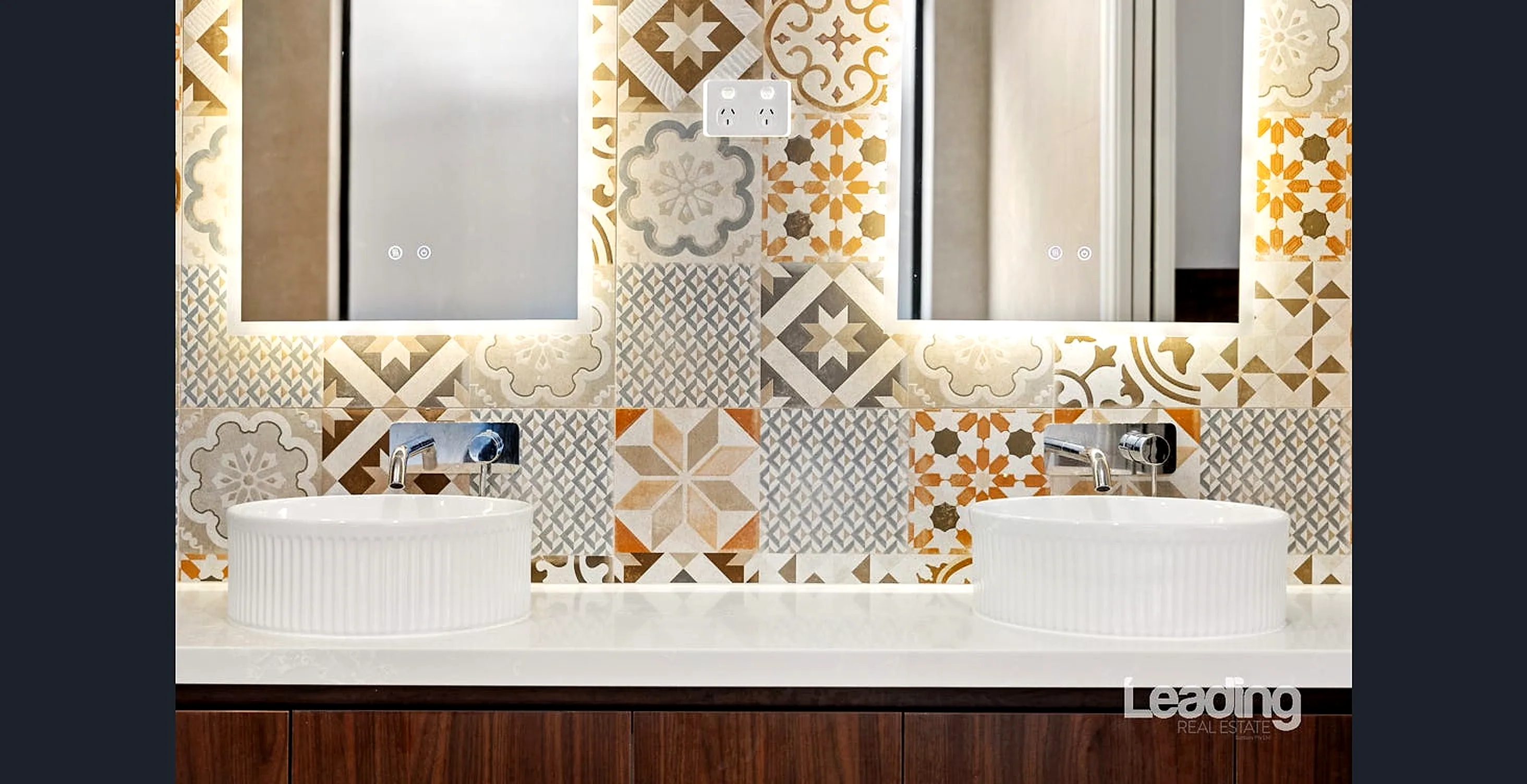 Master ensuite with a double vanity and full-height tiling
